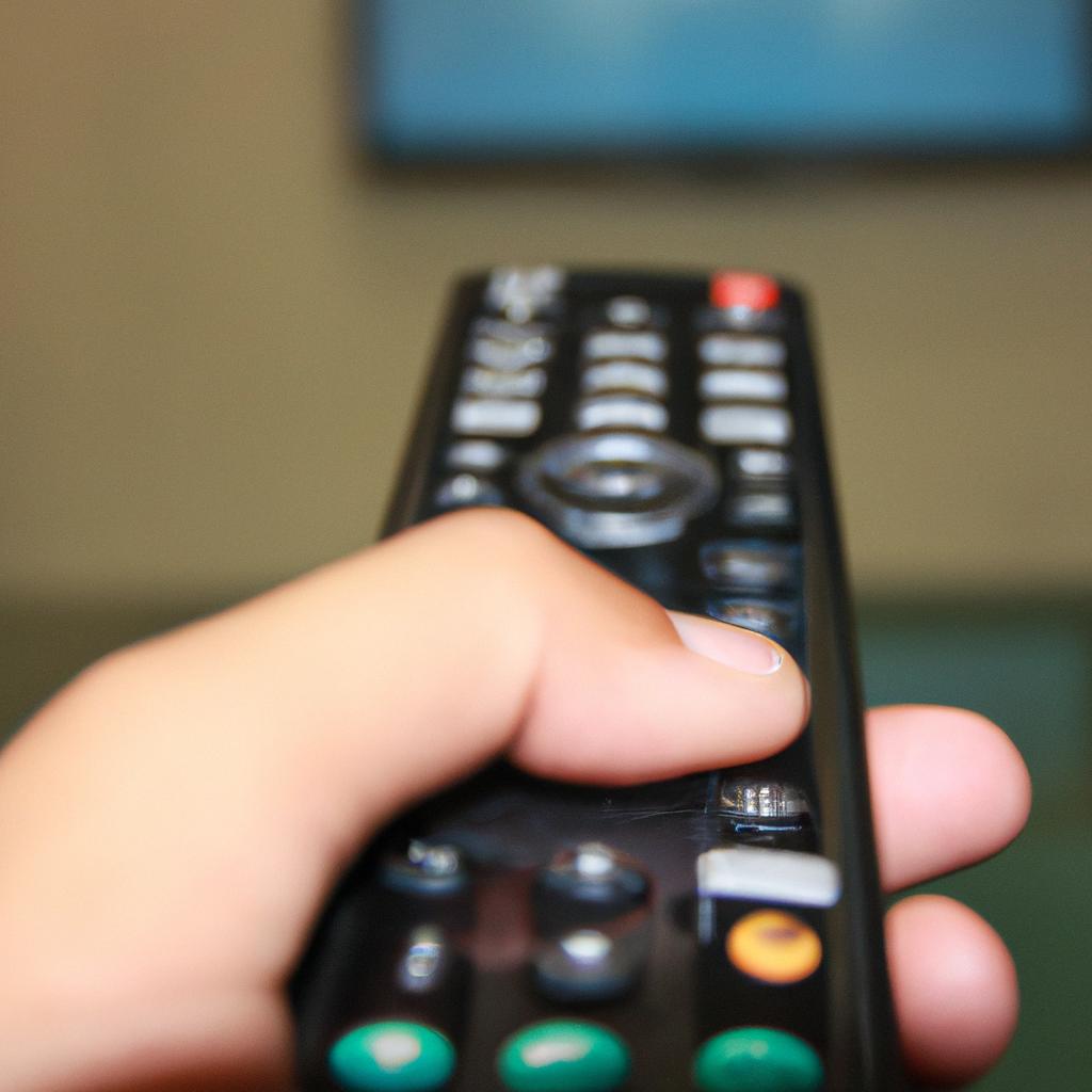 Person holding TV remote control